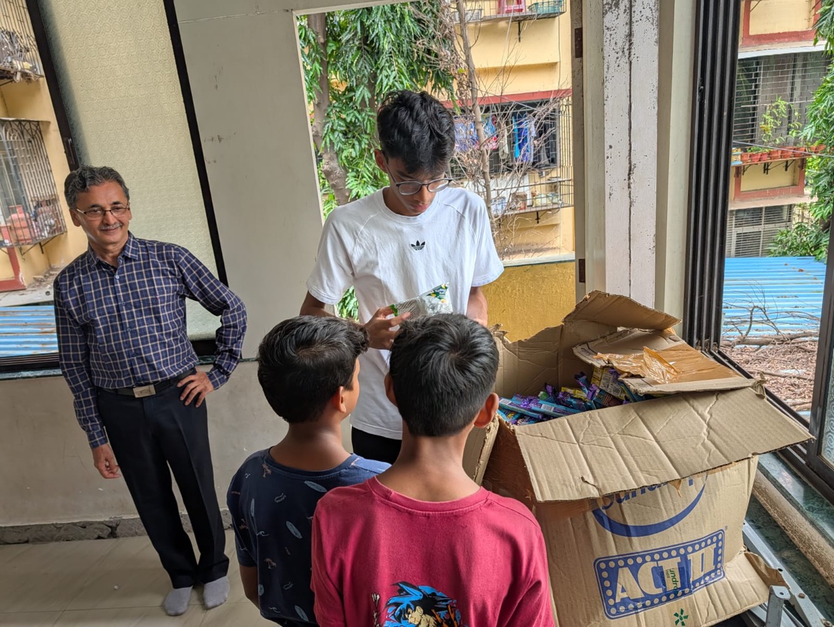 Handing out learning materials at an AngelXpress Foundation session